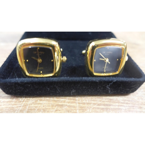 2142 - A pair of watch cufflinks