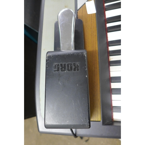 2215 - A Korg keyboard and stand with foot pedal (RH3 SP250)