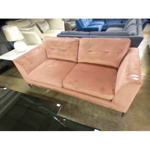 1503 - An Old Rose velvet upholstered three seater sofa on stiletto legs