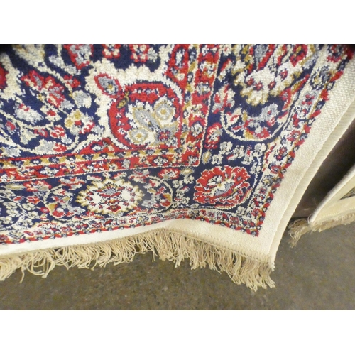 1545 - An ivory ground full pile cashmere runner with floral medallion design (300cm x 80cm)