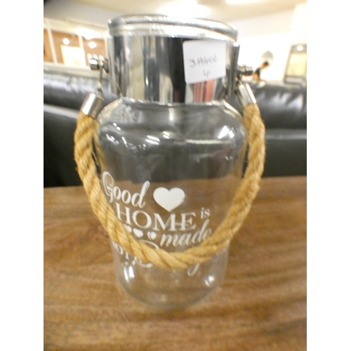 1391 - 'A Good Home is Made Not bought' clear vase with rope