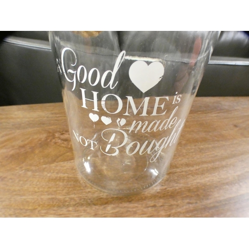 1391 - 'A Good Home is Made Not bought' clear vase with rope