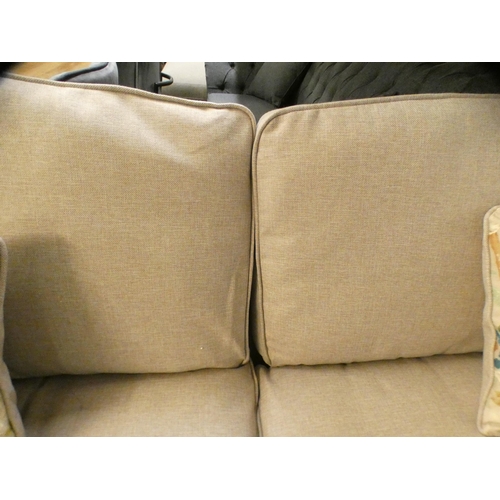 1416 - A light stone upholstered three seater sofa on turned legs