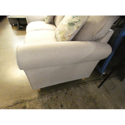 1416 - A light stone upholstered three seater sofa on turned legs