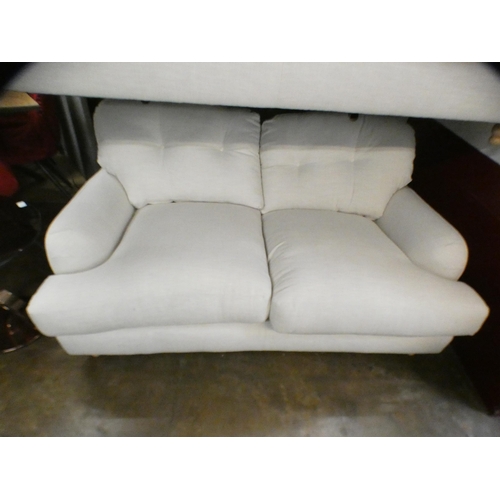 1434 - An ivory upholstered three and two seater sofa on turned legs