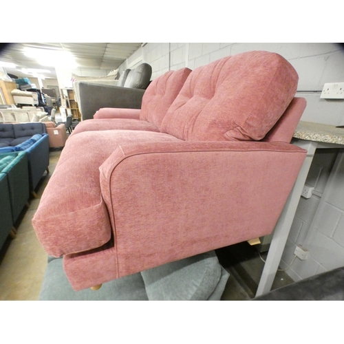 1442 - A sherbet upholstered three seater sofa on turned legs