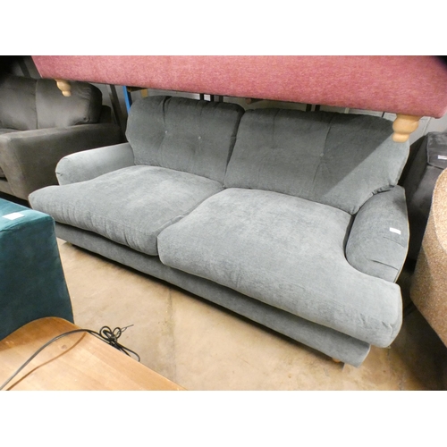 1443 - A teal upholstered three seater sofa on turned legs