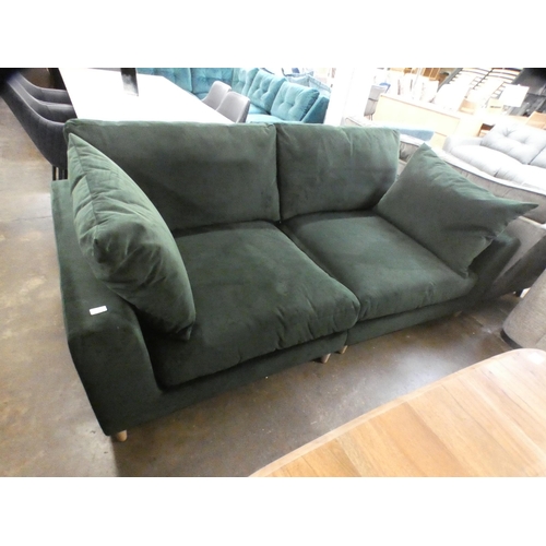 1468 - A green velvet three seater sofa