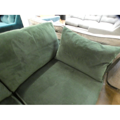 1468 - A green velvet three seater sofa