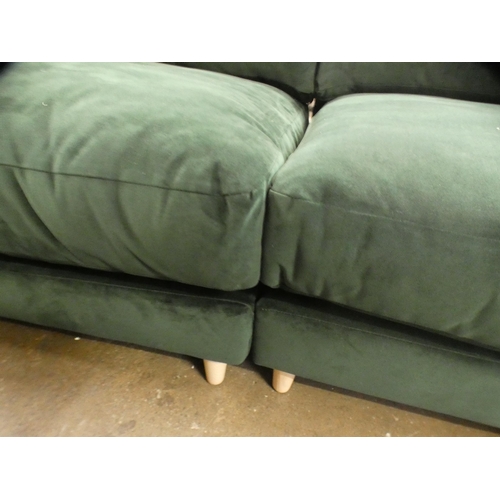 1468 - A green velvet three seater sofa