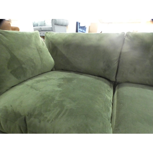 1468 - A green velvet three seater sofa