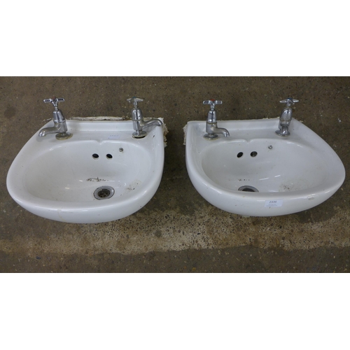 2336 - Two small wash hand basins, each with hot and cold taps