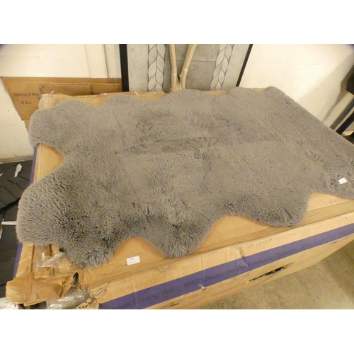 1597 - A grey faux fur rug