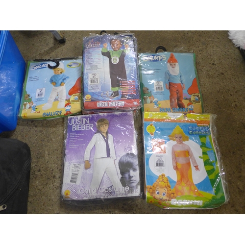 2380 - A box of children's fancy dress costumes including Smurfs, Green Lantern and Justin Beiber