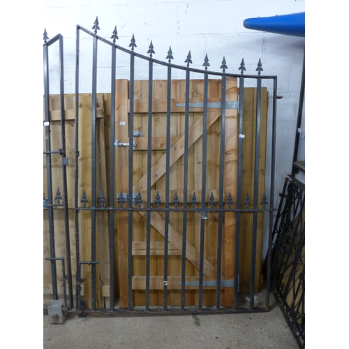 2432 - Wrought iron gates (approx. 7ft high x approx. 3m opening) with brackets for electric gate component... 