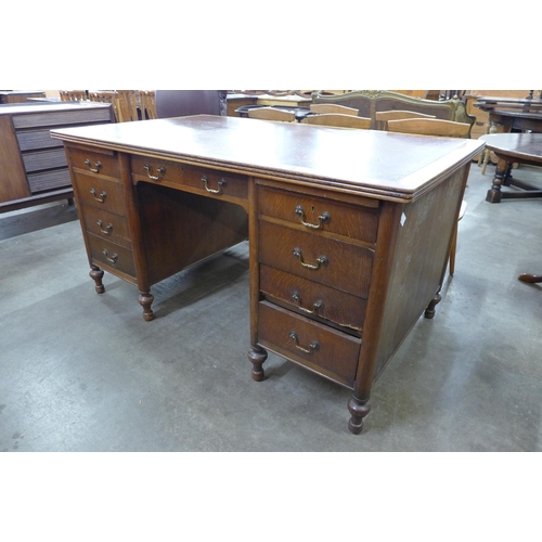 103 - An Edward VII oak and faux leather topped library desk