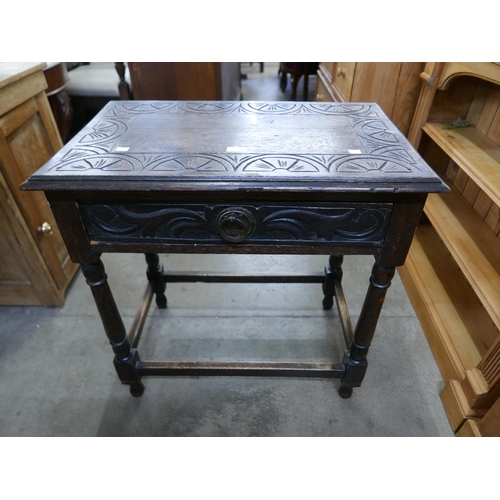 112 - A 17th Century style carved oak single drawer side table