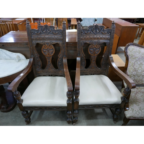 117 - A pair of Victorian Jacobean Revival carved oak open armchairs