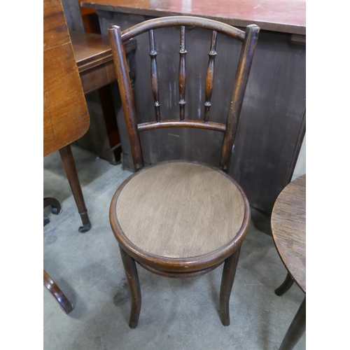 125 - A beech bentwood occasional table and two chairs