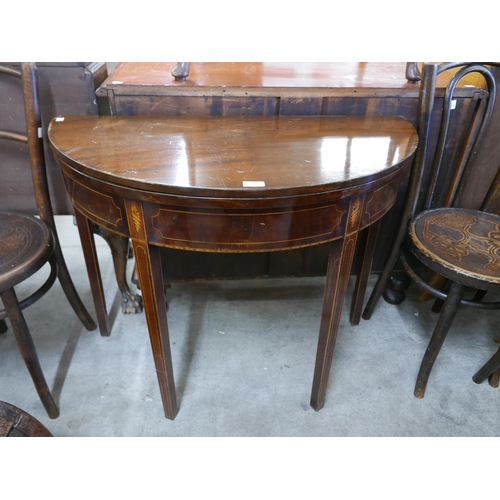 127 - A George III inlaid mahogany demi lune fold over tea table