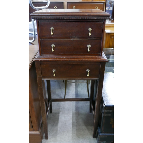 134 - An Edward VII oak three drawers chest on stand