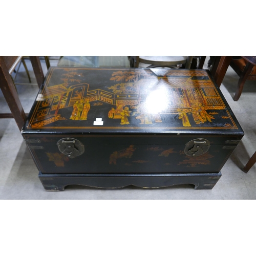 135 - An oriental black chinoiserie blanket box