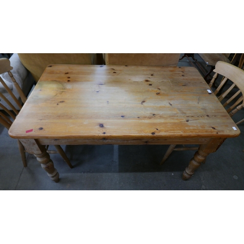 146 - A pine single drawer kitchen table and a four beech chairs