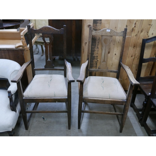 150 - A pair of Arts and Crafts oak elbow chairs