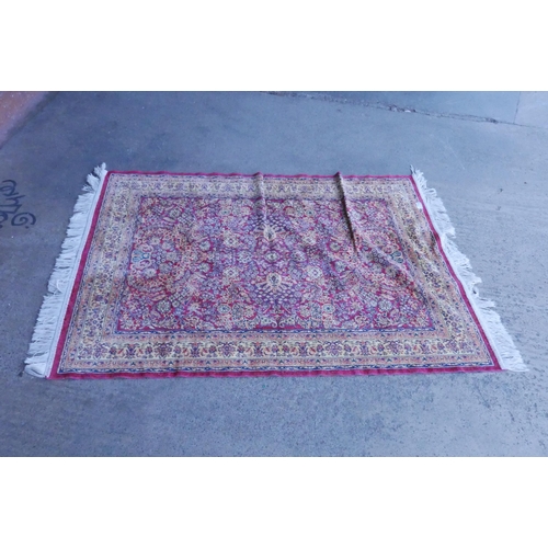 187 - An eastern red ground rug