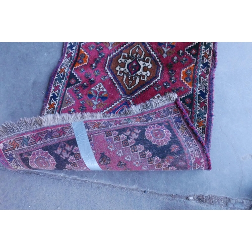 188 - An eastern red ground runner rug