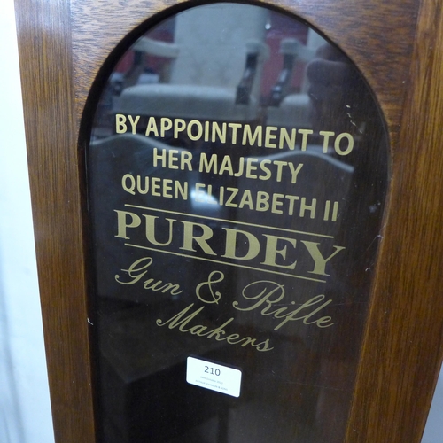 210 - A glazed oak single door cabinet, bearing Purdey Gun & Rifle Makers inscription to door