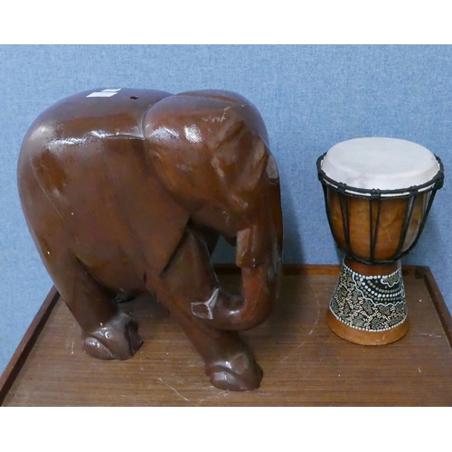 277 - An African drum and a wooden Indian carved wood elephant