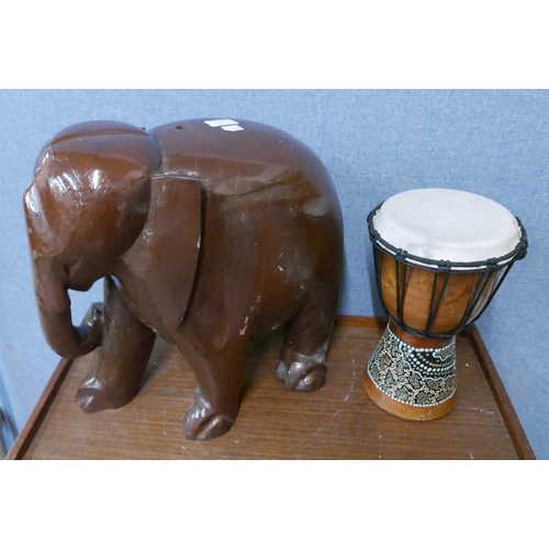 277 - An African drum and a wooden Indian carved wood elephant