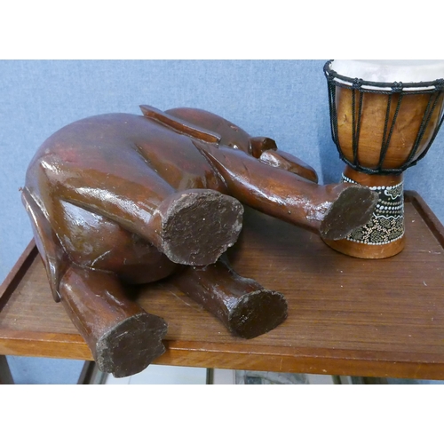 277 - An African drum and a wooden Indian carved wood elephant