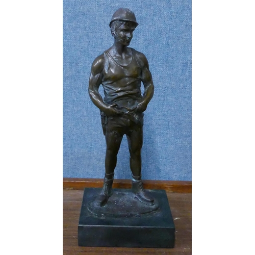 281 - A bronze figure of a miner