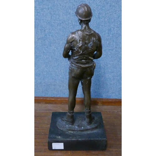 281 - A bronze figure of a miner