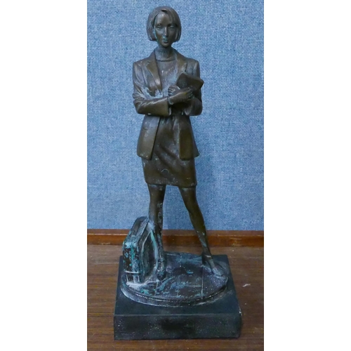 282 - A bronze figure of a female office worker