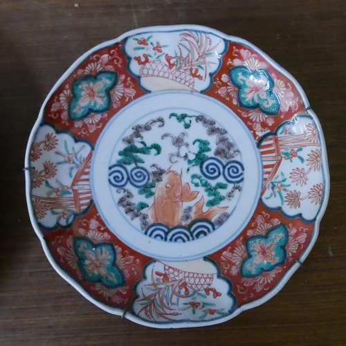 292 - A Japanese famille noir porcelain charger and an Imari pattern dish