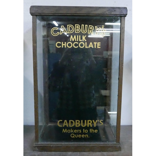 295 - An early 20th Century glazed oak counter top shop display cabinet, bearing Cadbury's inscription