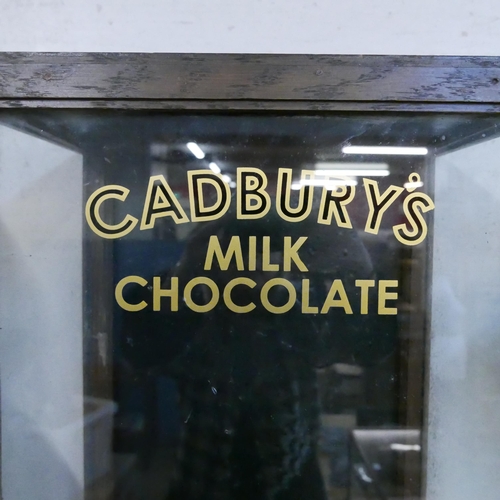 295 - An early 20th Century glazed oak counter top shop display cabinet, bearing Cadbury's inscription