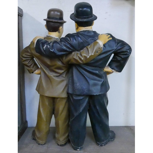 296 - A painted Laurel and Hardy figure