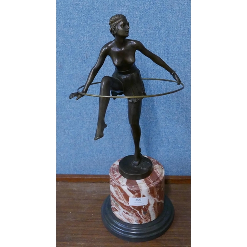 300 - An Art Deco style bronze figure of a dancing hoop girl, on rouge marble socle