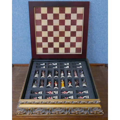 301 - A Napoleonic figural chess resin set, in a table top box with board