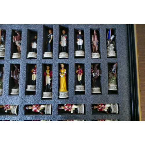 301 - A Napoleonic figural chess resin set, in a table top box with board