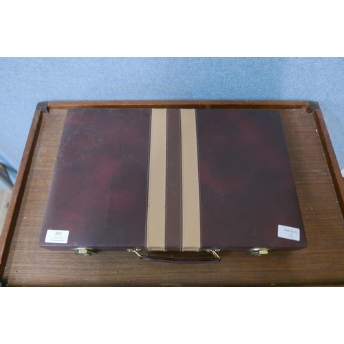 302 - A cased backgammon set