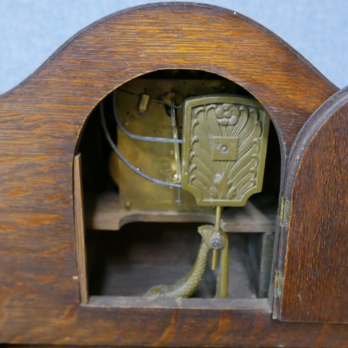 304 - Two early 20th Century carved oak mantel clocks