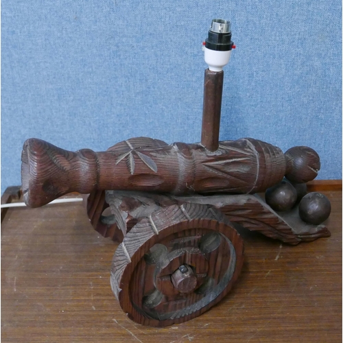 308 - A carved cannon shaped table lamp