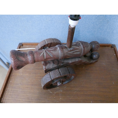 308 - A carved cannon shaped table lamp