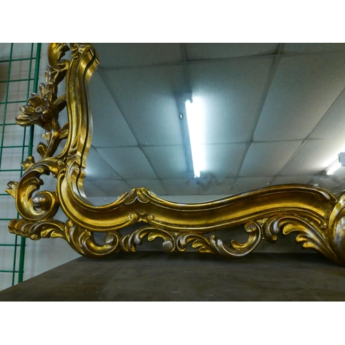 313 - A Rococo style gilt framed overmantel mirror and one other