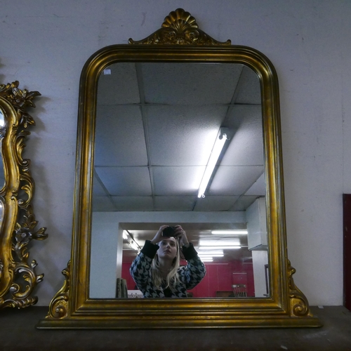 313 - A Rococo style gilt framed overmantel mirror and one other